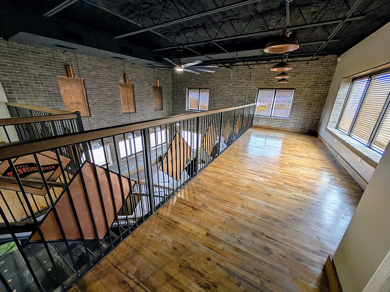 Balcony area overlooks living room.