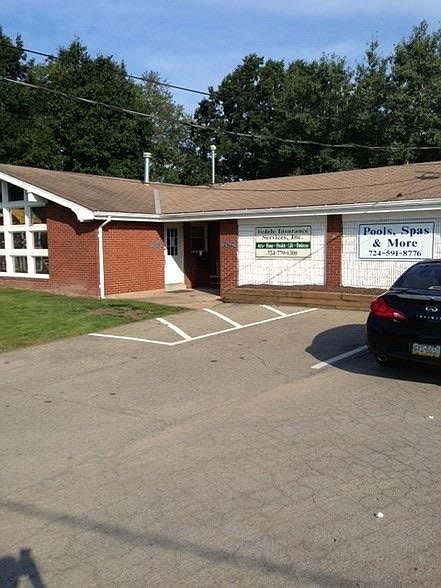 Business on left side of building and apartment on right side