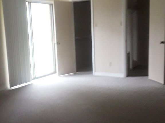 Master bedroom with 2 closets, leads to small patio area