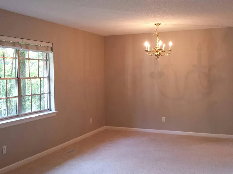 Large living room or Living/Dining room with large updated double pane windows, looking from stairs to possible dining area