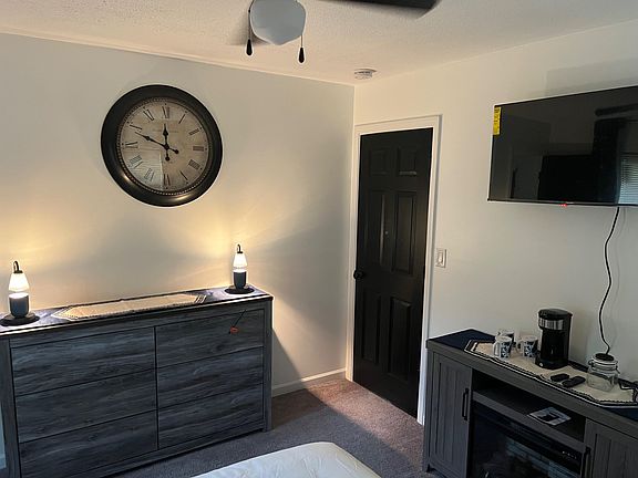 Bedroom includes a dresser and TV area, plus a convenient beverage station for everyday comfort.
