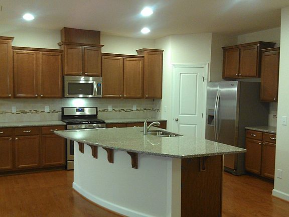 Gas Range, large island with bar overhang, corner pantry.