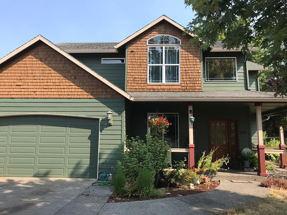 Water fountain in front of wrap around covered porch