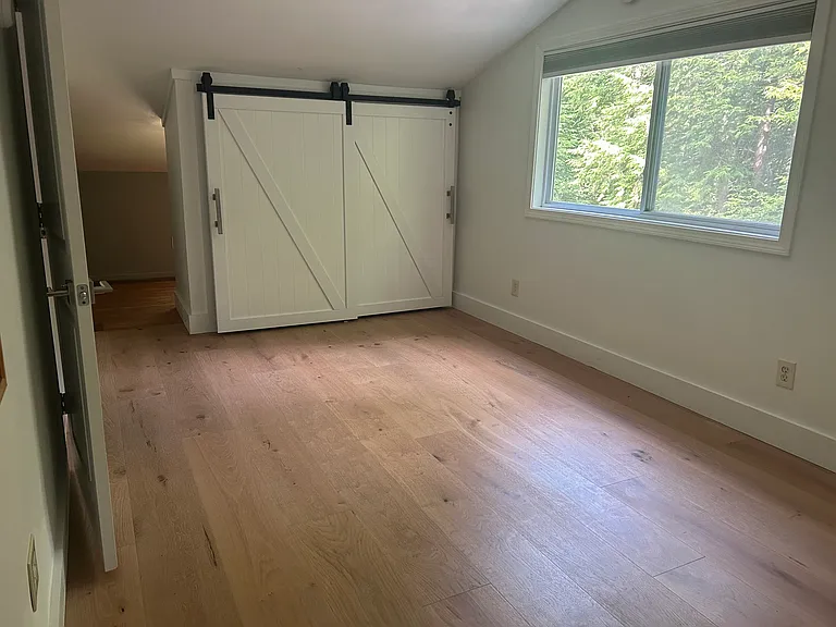 bedroom with storage behind closet