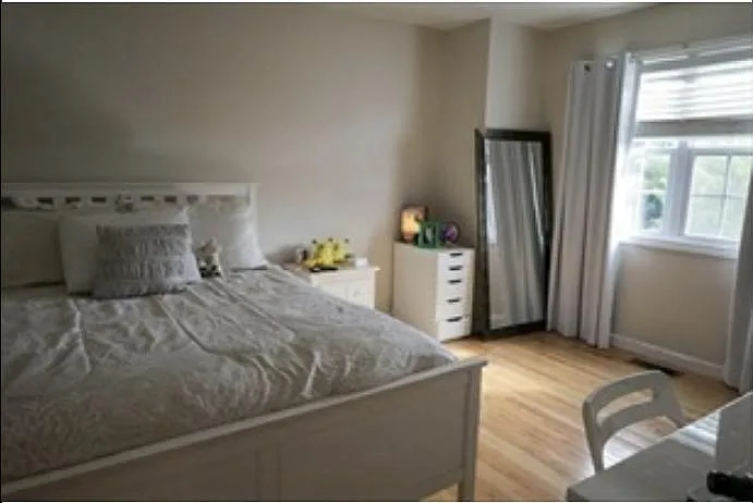 large, light 3rd floor bedroom with ceiling fan and double closet