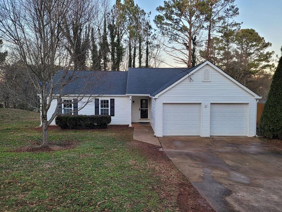 Fairly driveway, Ring flood light camera (not installed on this pic). Vinyl siding.