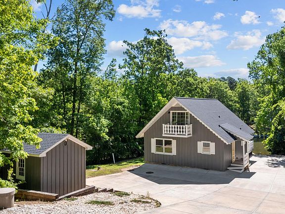 Storage shed and paved parking area. Additional gravel parking available at the top of the driveway