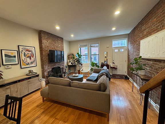 Living Room with exposed brick wall