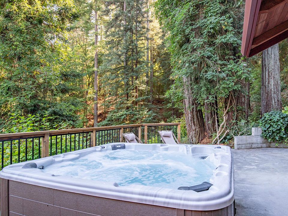 Relax in the outdoor private hot tub in the woods.