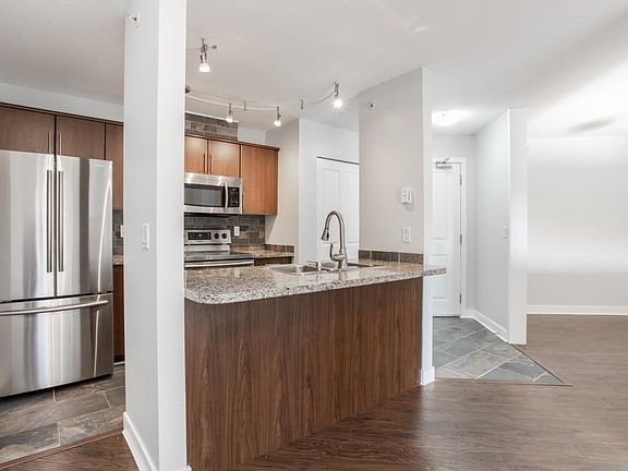 Open concept kitchen with stainless steel appliances and granite countertops
