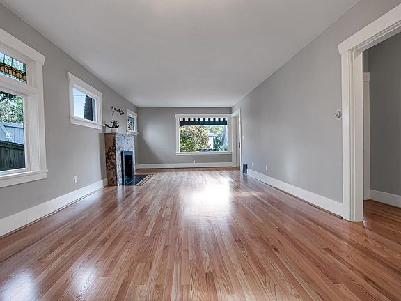 Gleaming newly refinished hardwoods and freshly painted interior. Expansive open living/dining room includes fireplace and original leaded windows.