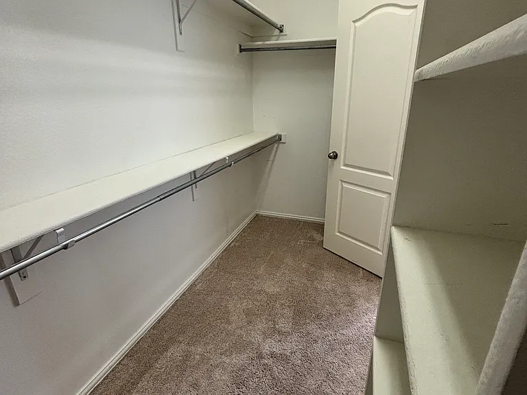 Master Closet 11.5'x5'. Double Racks and Build in Shelves. Matching Wood look tile will be installed 7/2026.