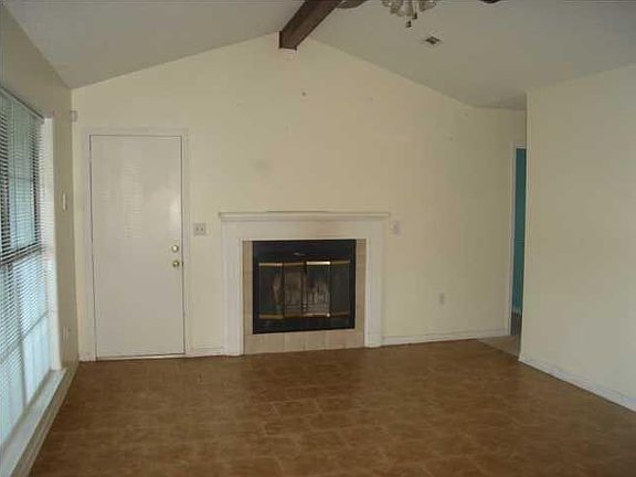 Living room with fireplace and vaulted ceiling