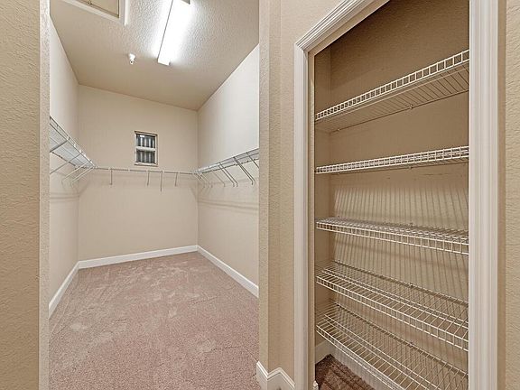 Large master closet with plenty of storage and natural light.