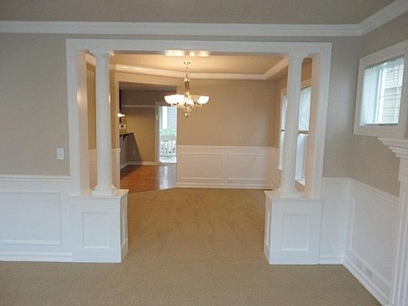 View from living room through dining room towards family room off of kitchen