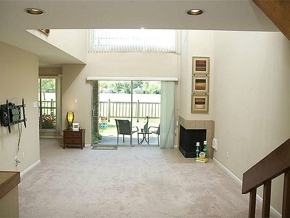 The large family room has a high ceiling and a cozy gas fireplace.