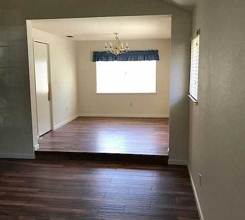 Formal dining room adjoins the living room and it has a door to the kitchen the view is to the pool and backyard.