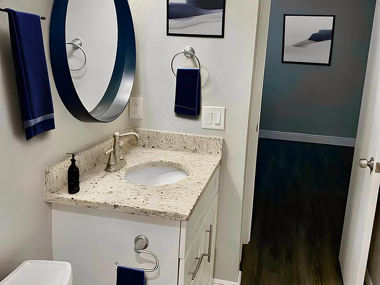 Luxury bathroom with granite countertops & tons of storage. Linen closet attached for additional storage.