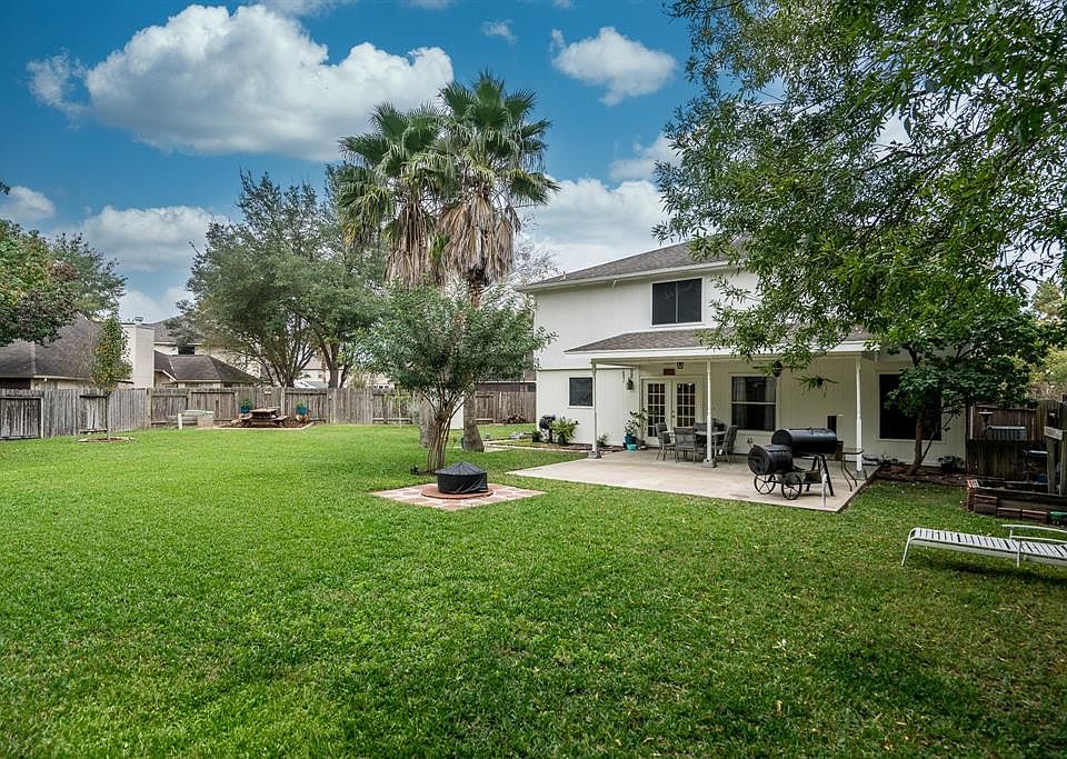 Huge backyard! Look at all the space-picnic area, fire pit, and covered patio.