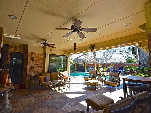Look at this wonderful backyard for entertaining!! Ceiling fans here also!!