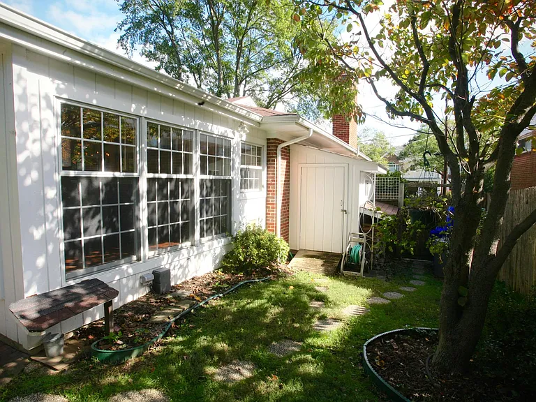 Shed by side entrance for storing bicycles, yard equipment, etc.