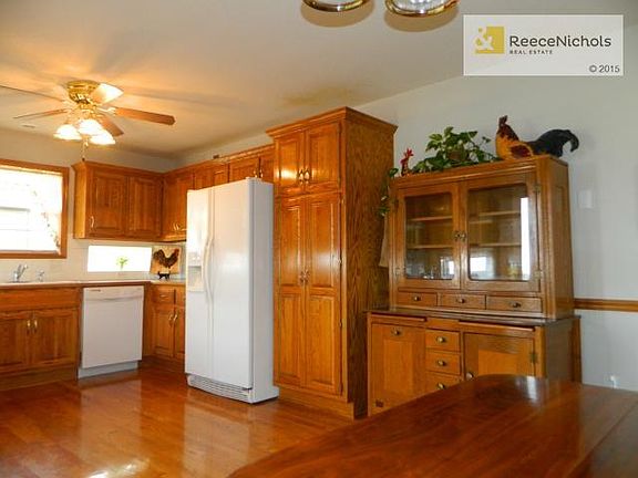 The ceiling fan and chair rail makes this kitchen beautiful! Don