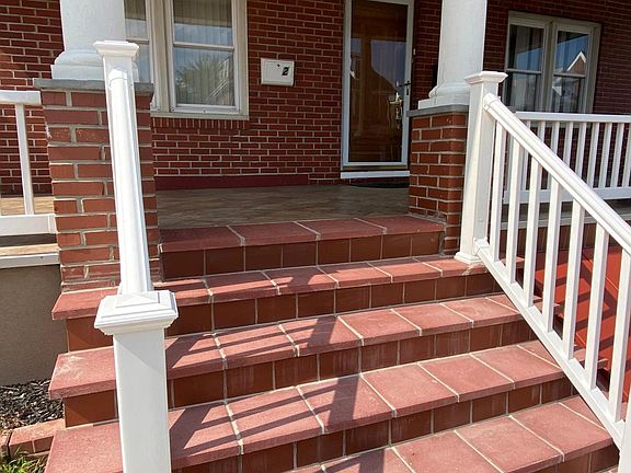 Large impressive brick and tile front porch.