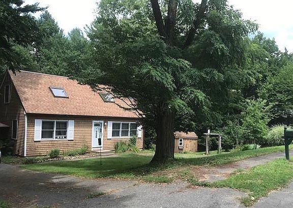 Street view, driveway. Front windows face south with good winter light.