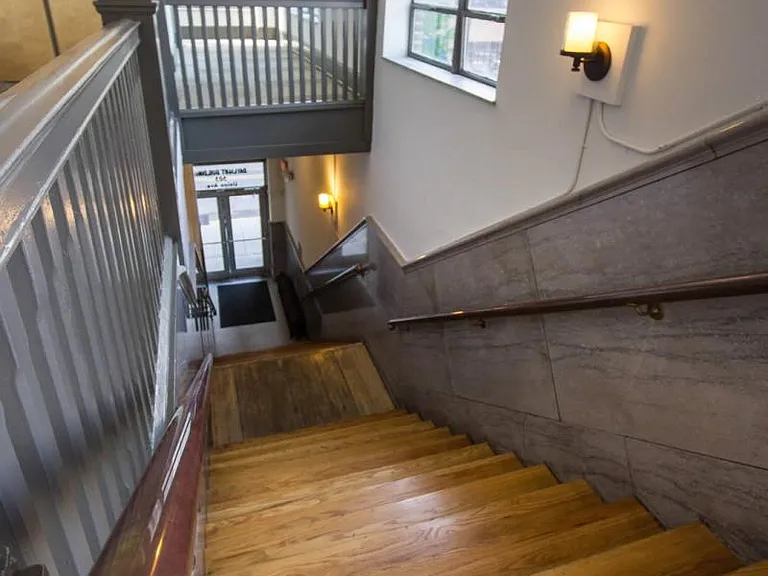 Marble, wood and bronze entry staircase and large elevator