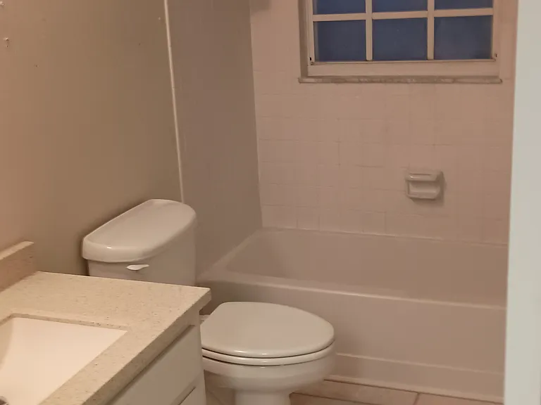Bathroom from kitchen door entrance. There is a closet to the right that has the washer/ dryer.