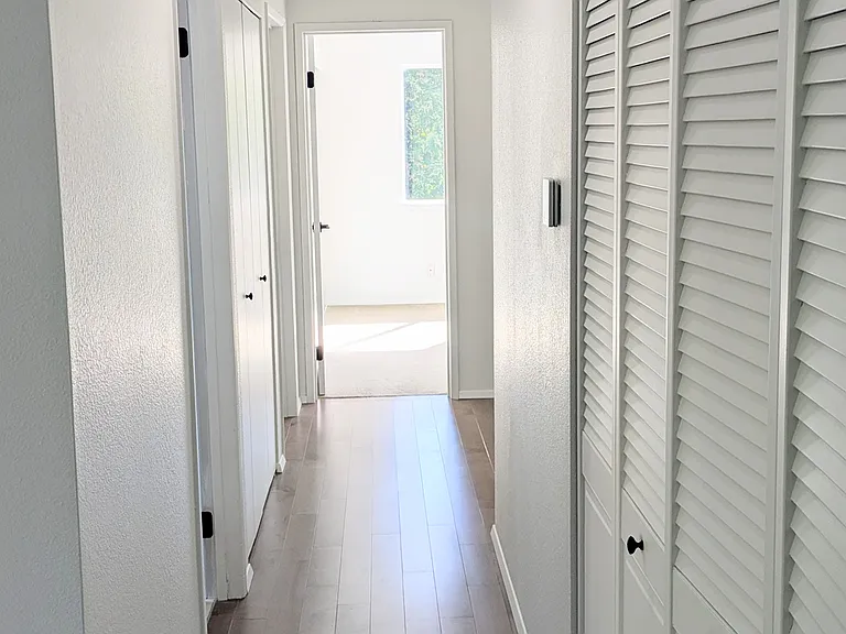 Main floor hallway with coat and linen closets and 4 bedrooms all together