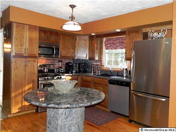 Updated kitchen with STAINLESS STEEL APPLIANCES, pantry, wood flooring, Frigidare range/convection oven with 5 burners & warming tray, GE built in microwave, dishwasher.