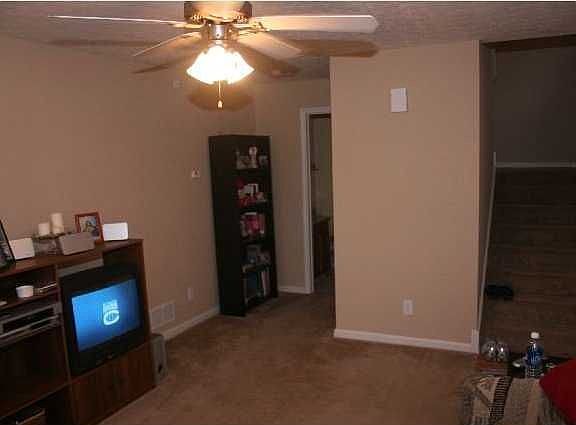 Living Room w/ view to half bathroom and stairwell.