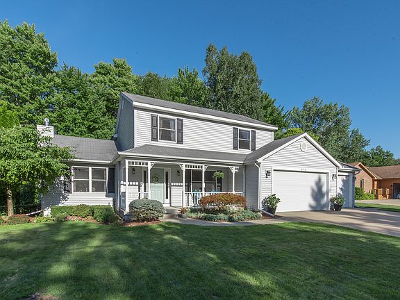 An inviting front porch and landscaped lawn welcomes you home.  The southern charm inspired front door sets the tone for this home's stylish interior and welcoming atmosphere. 