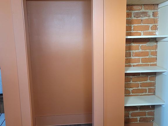 Unit offers ample storage with a closet, shelving and under the bed drawers.