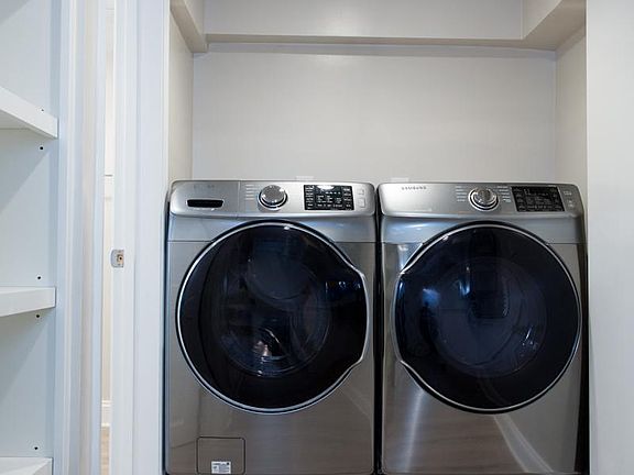 Tenant's own laundry room with built-in storage.