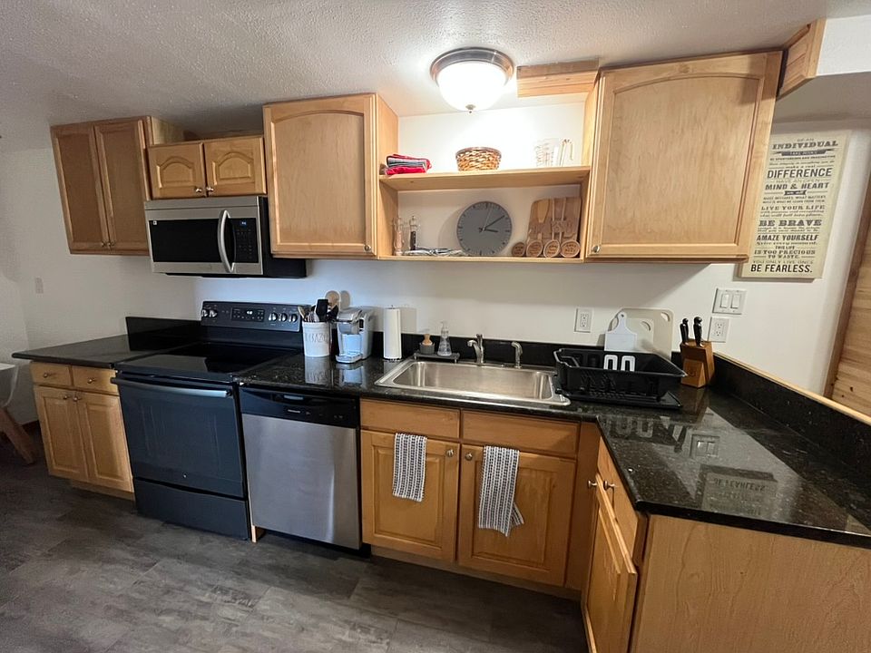 Fully stocked kitchen with new microwave, dishwasher, and stove