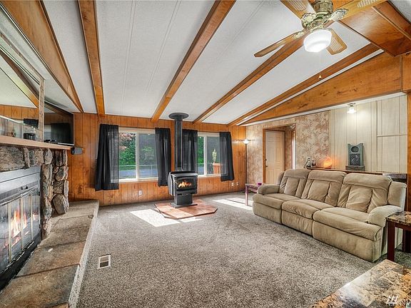 High vaulted ceilings with wood beams invite you into this light and bright home.