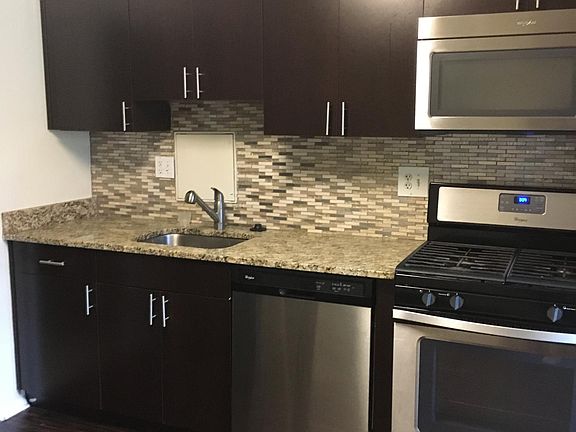 Stainless steel kitchen appliances, fridge w/ice maker, gas stove.