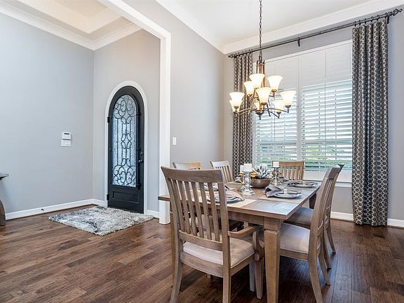 This formal dining room is to the left of the entryway. The gorgeous light fixture will make your dining furniture look fabulous, in this ample sized room.