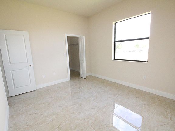 View of Bedroom with Window and entrance to walk-in closet