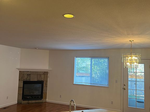 Kitchen opens to living room with gas fireplace