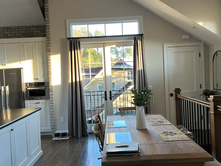 The dining area's French doors overlook the garden area below.
