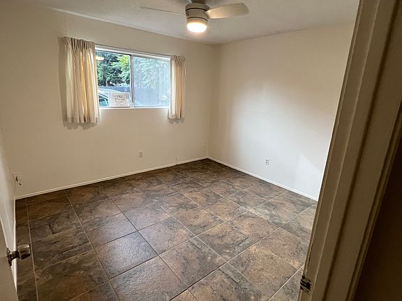 Spacious main bedroom with cooling fan and large closet
