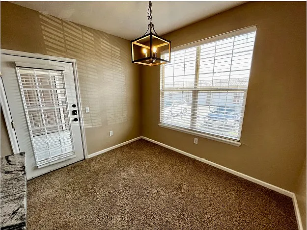Dining room with back door (left) leading to porch shared with first bedroom.