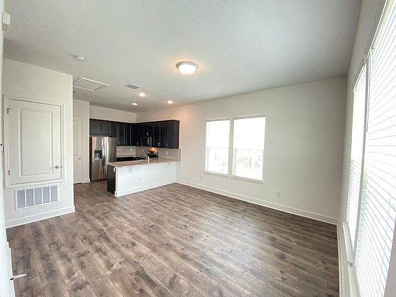 The view after going up the stairs. Family room with the kitchen in the background.