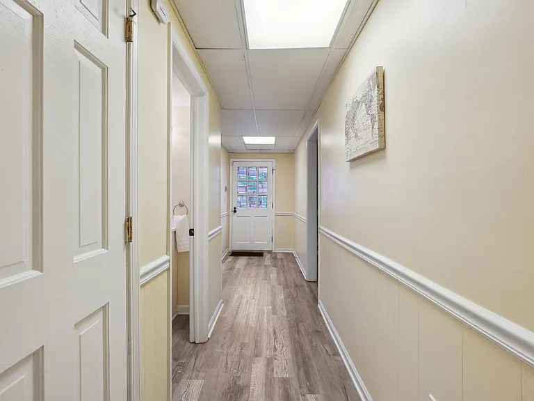 Basement Level Hallway with exterior door to Backyard pool level