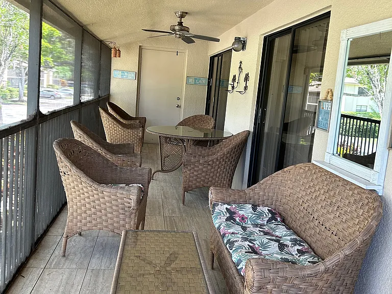 Large screened patio with table, chairs and two loungers