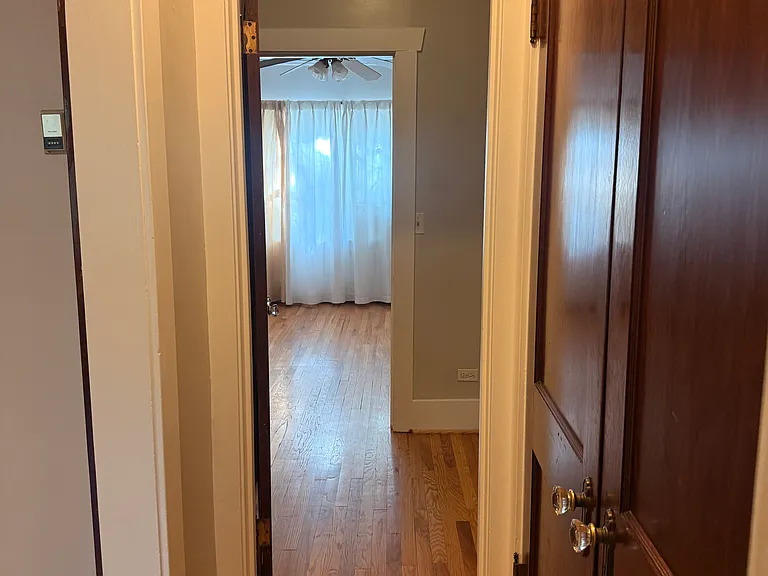 View from bathroom through closet to the bedroom.