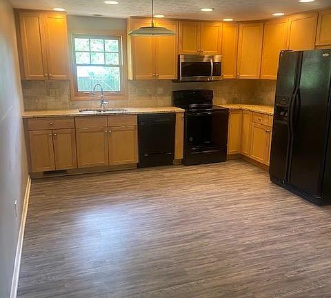 Updated kitchen with 42" cabinets and a new range and microwave.